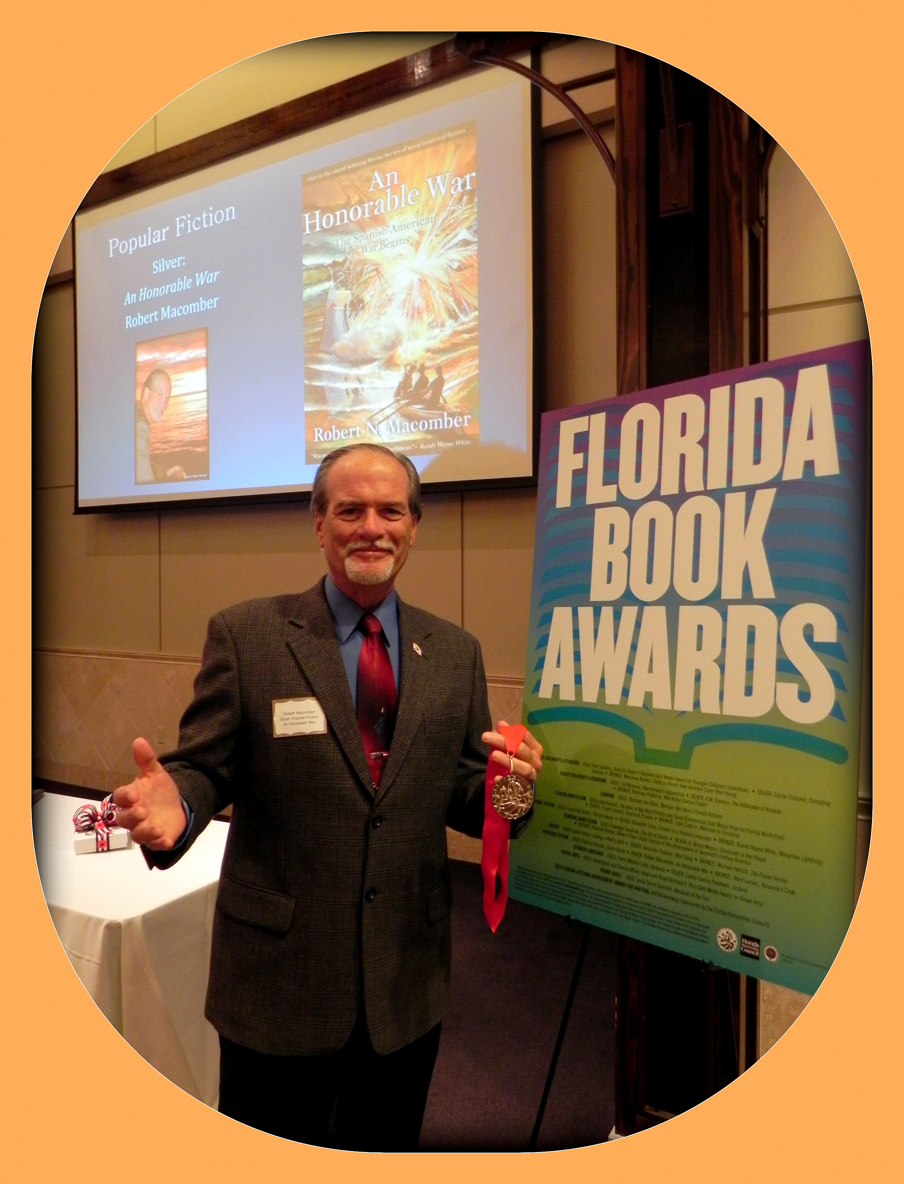 Robert N. Macomber wins the Silver Medal in the category, Popular Fiction, from the Florida Book Awards in Tallahassee, FL for the 13th novel in his Honor Series, titled: *An Honorable War*.